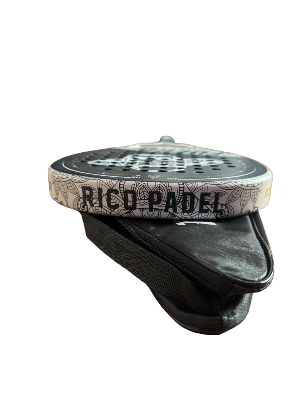 Close-up of the Fuego racquet edge and sand-textured finish